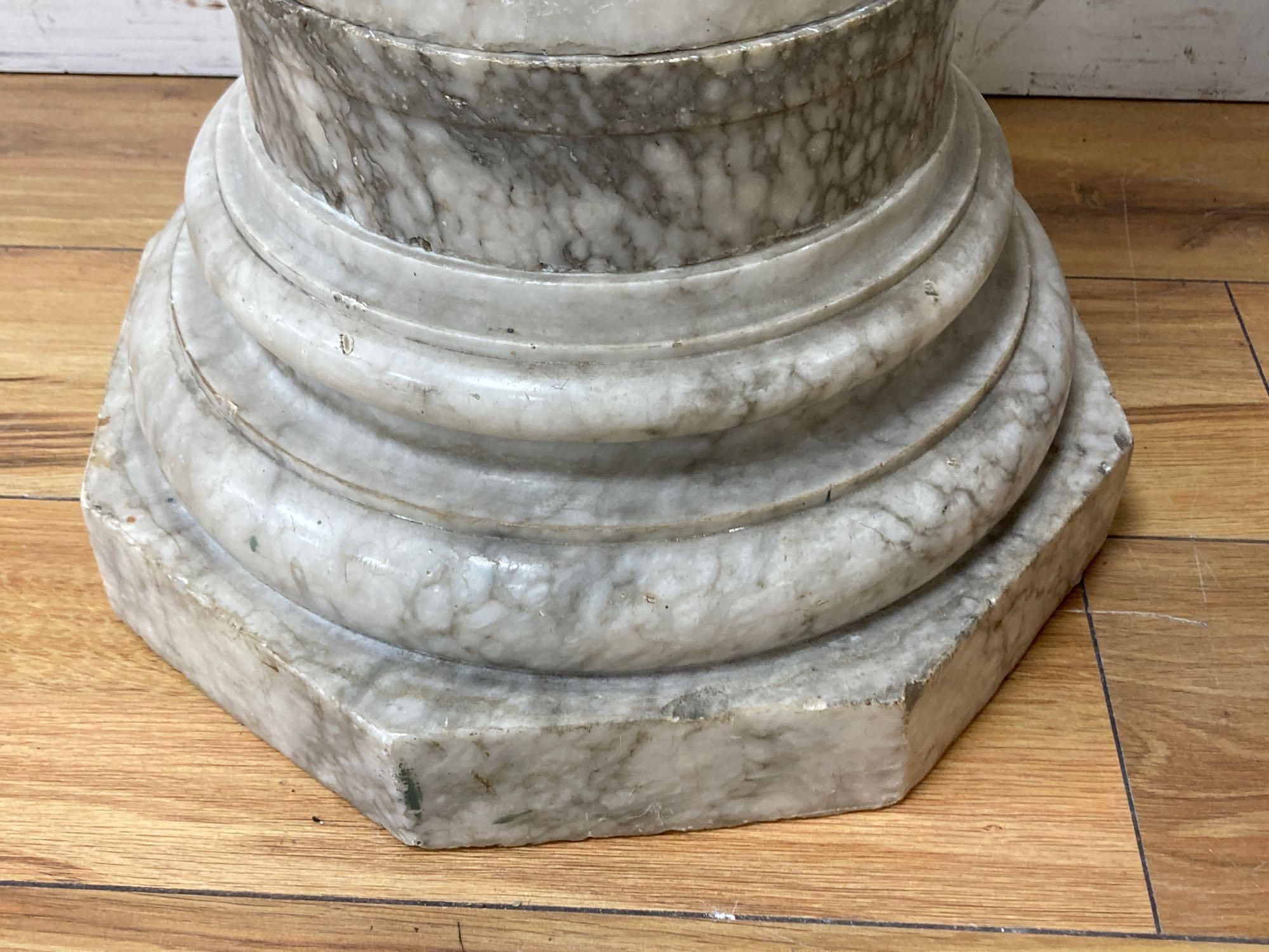 A variegated cream marble pedestal, height 110cm